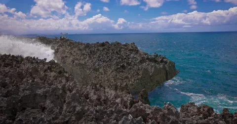 Slow motion of large waves crashing against the rocks of the coastline. Stock Footage 256449623