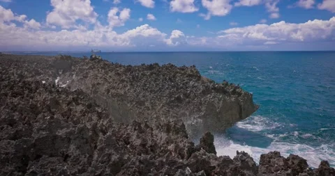 Slow motion of large waves crashing against the rocks of the coastline. Stock Footage 256449689