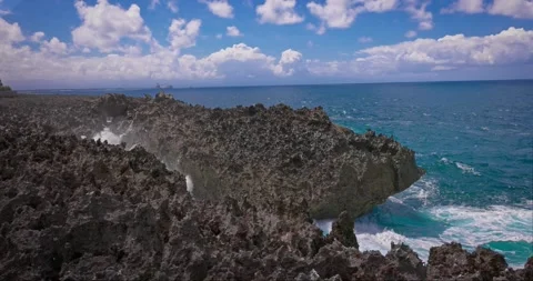 Slow motion of large waves crashing against the rocks of the coastline. Stock Footage 256449732