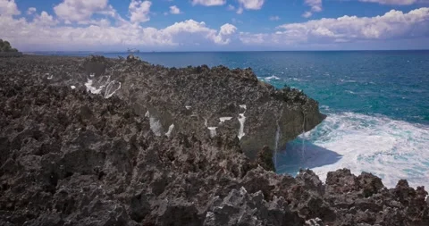 Slow motion of large waves crashing against the rocks of the coastline. Stock Footage 256449900