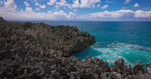 Slow motion of large waves crashing against the rocks of the coastline. Stock Footage 256449953