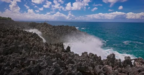 Slow motion of large waves crashing against the rocks of the coastline. Stock Footage 256450055