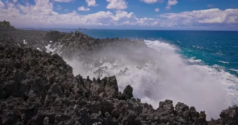 Slow motion of large waves crashing against the rocks of the coastline. Stock Footage 256450262