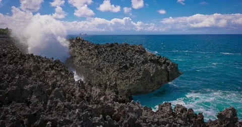 Slow motion of large waves crashing against the rocks of the coastline. Stock Footage 256450354