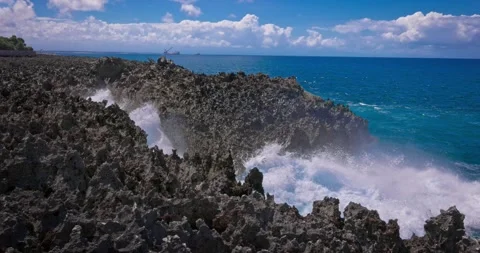 Slow motion of large waves crashing against the rocks of the coastline. Stock Footage 256450508