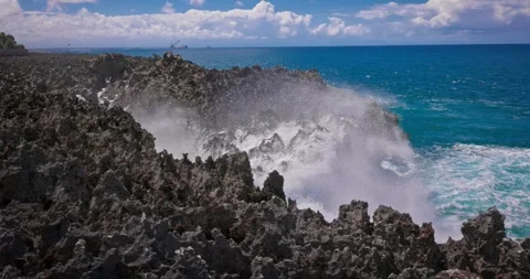 Slow motion of large waves crashing against the rocks of the coastline. Stock Footage 256450547