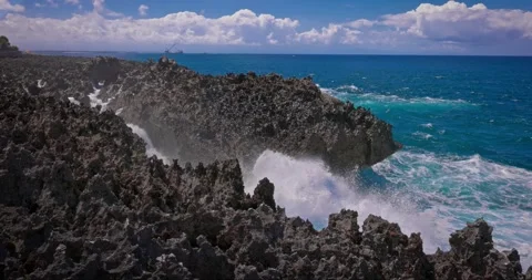 Slow motion of large waves crashing against the rocks of the coastline. Stock Footage 256450662