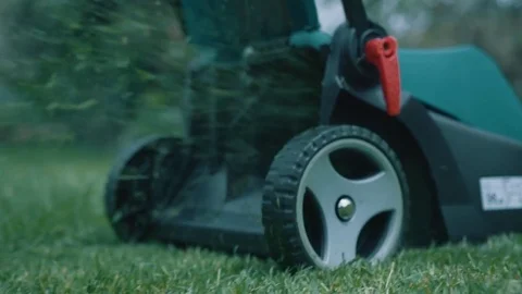 Slow motion lawn mower cutting grass Stock Footage 71996800