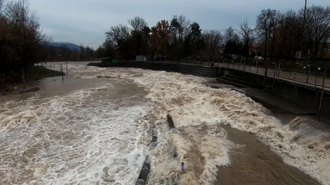 Slow motion left pan raging brown flooded water wide Sava river Stock Footage 122204424