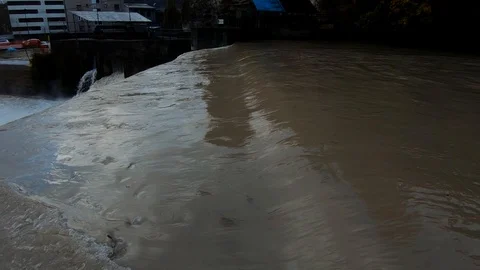 Slow motion left pan water flooding in industrial area Stock Footage 120528607