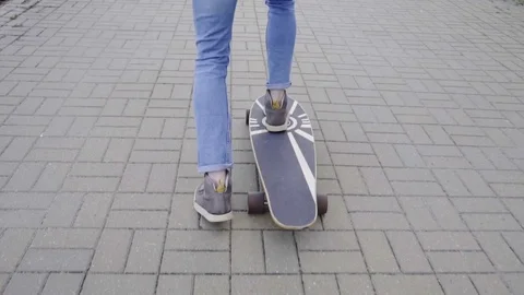 Slow motion of legs picking up and riding the board Stock Footage 75823945