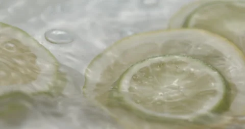 Slow Motion Lemons Splashing into Water - Refreshing Citrus Footage Stock Footage 273531400