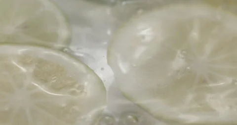 Slow Motion Lemons Splashing into Water - Refreshing Citrus Footage Stock Footage 273531420