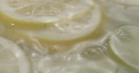 Slow Motion Lemons Splashing into Water - Refreshing Citrus Footage Video stock 273531478