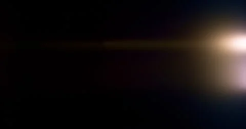 Slow motion of lens flare isolated on black background. Anamorphic lens. Stock Footage 335508292
