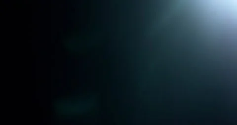 Slow motion of lens flare isolated on black background. Anamorphic lens. Stock Footage 335508437