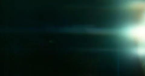 Slow motion of lens flare isolated on black background. Anamorphic lens. Stock Footage 335508524