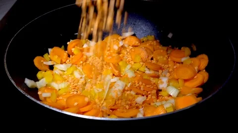 Slow motion: Lentils falling onto chopped vegetables. Stock-Footage 89026200