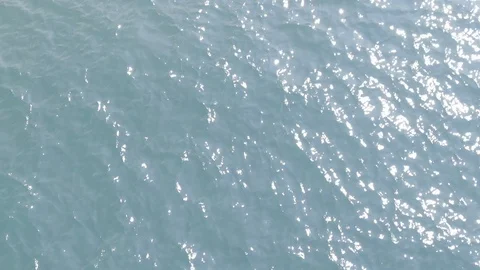 Slow motion of light blue wave moving in the sea with sun reflection. Stock Footage 129115433