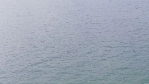 Slow motion of light blue wave moving in the sea with sun reflection. Stock Footage 129116179