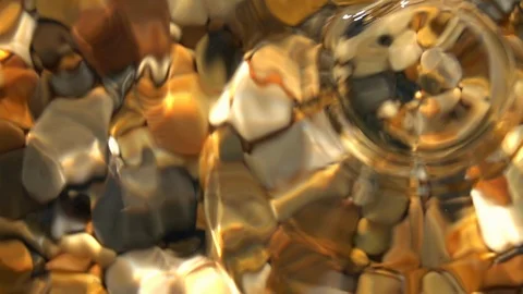 Slow motion of light rain with round waves in shallow pure water close up. Stock Footage 98095340