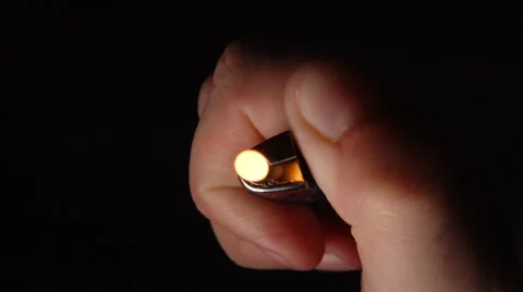 SLOW MOTION: A lighter fires in a human hand Stock Footage 65173093