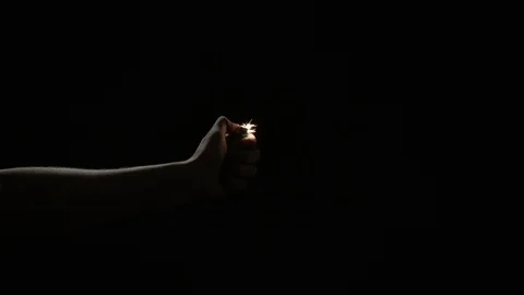 Slow motion lighter ignition with arm on black background for use with visual Stock Footage 92582730