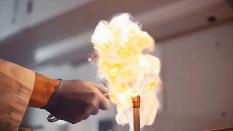 Slow motion lighting a bunsen burner in a science laboratory Stock Footage