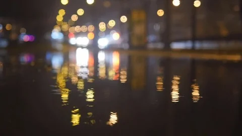 Slow motion lights bokeh circles reflecting in water on night city street Stock Footage 70519735