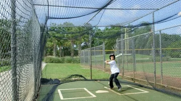 Slow motion of little boy batting at batting cages Stock Footage 85653520