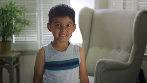 Slow motion of little boy looking at the camera and making faces Stock Footage 92222285