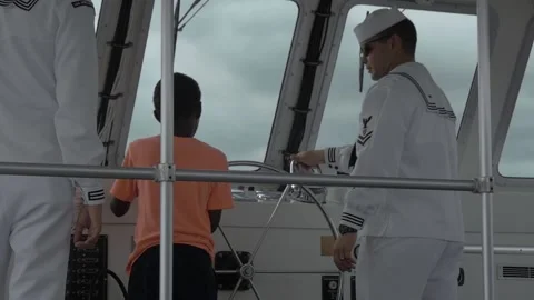 Slow Motion Little Boy Steers Navy Boat To USS Arizona, Pearl Harbor, Hawaii Stock Footage 154499736