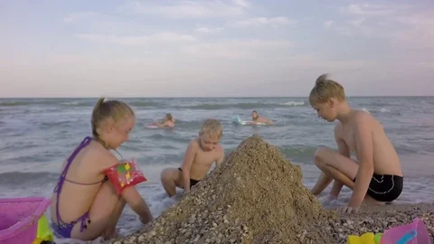 Slow motion. Little Children Playing With Sand Toy On The Beach. Video stock 84264530