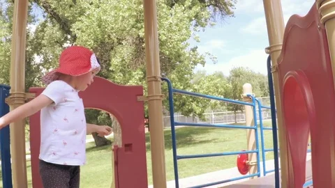 Slow motion. Little girl playing on the kids playground in the Summer. Stock Footage