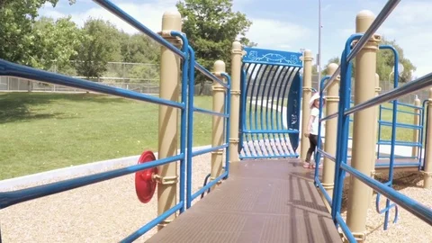 Slow motion. Little girl playing on the kids playground in the Summer. Stock Footage