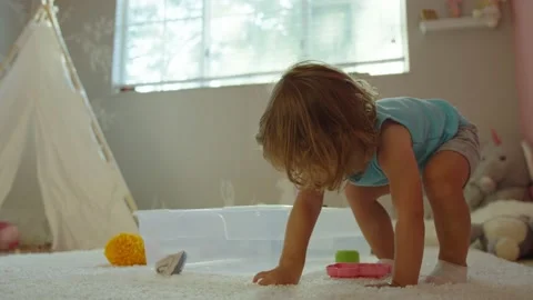 Slow motion of little girl playing in her room Stock Footage 140470853