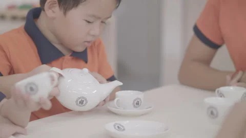Slow motion a little kid is preparing tea at kindergarten Stock Footage 133895746