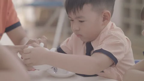 Slow motion a little kid is preparing tea at kindergarten Stock Footage 133895807