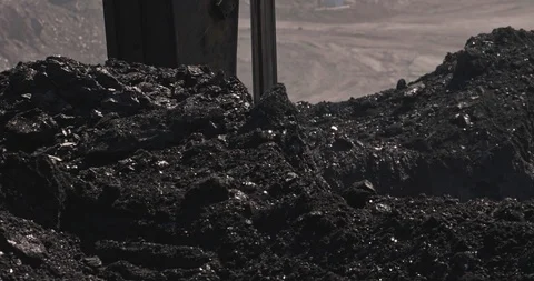 Slow motion loading of an excavator into mining truck. Excavator loading coal in Stock Footage 111333323