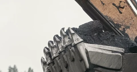 Slow motion loading of an excavator into mining truck. Close-up Excavator Stock Footage 122339713