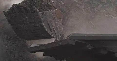 Slow motion loading of an excavator into mining truck. Close-up Excavator Stock Footage 122340082