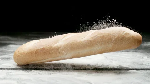SLOW MOTION: Loaf of Bread Falling Down On A Flour on a Black Surface Видео 167990541