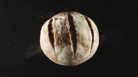 SLOW MOTION: Loaf Of Dark Bread Falling Down On A Black Table Видео 115958442
