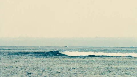 Slow motion Long Lens shot of surfing in Indonesia Stock Footage 79660920