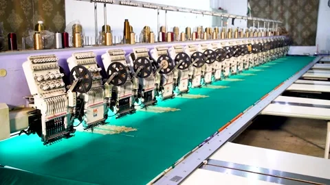 Slow motion long shot of automatic embroidery machine with multiple heads in Stock Footage 199271934