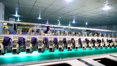 Slow motion long shot of automatic embroidery machine with multiple heads in Stock Footage 199271937