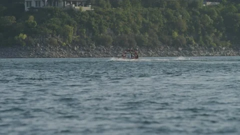 Slow motion long shot of wake surf boat in Lake Travis Texas in summer Stock Footage 234036393