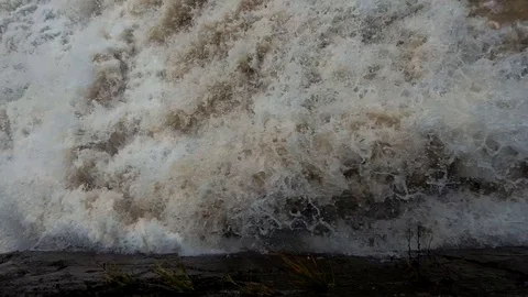 Slow motion looking down on flooded rapid river water Stock Footage 120528730