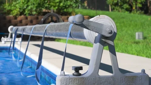 Slow motion looking left over a pool cover on a hot summer morning. Stock Footage 342078678