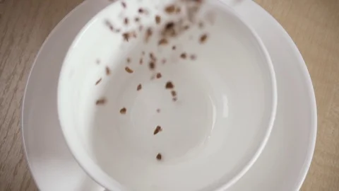 Slow motion lots of instant coffee strews into a cup Stock Footage 88823172